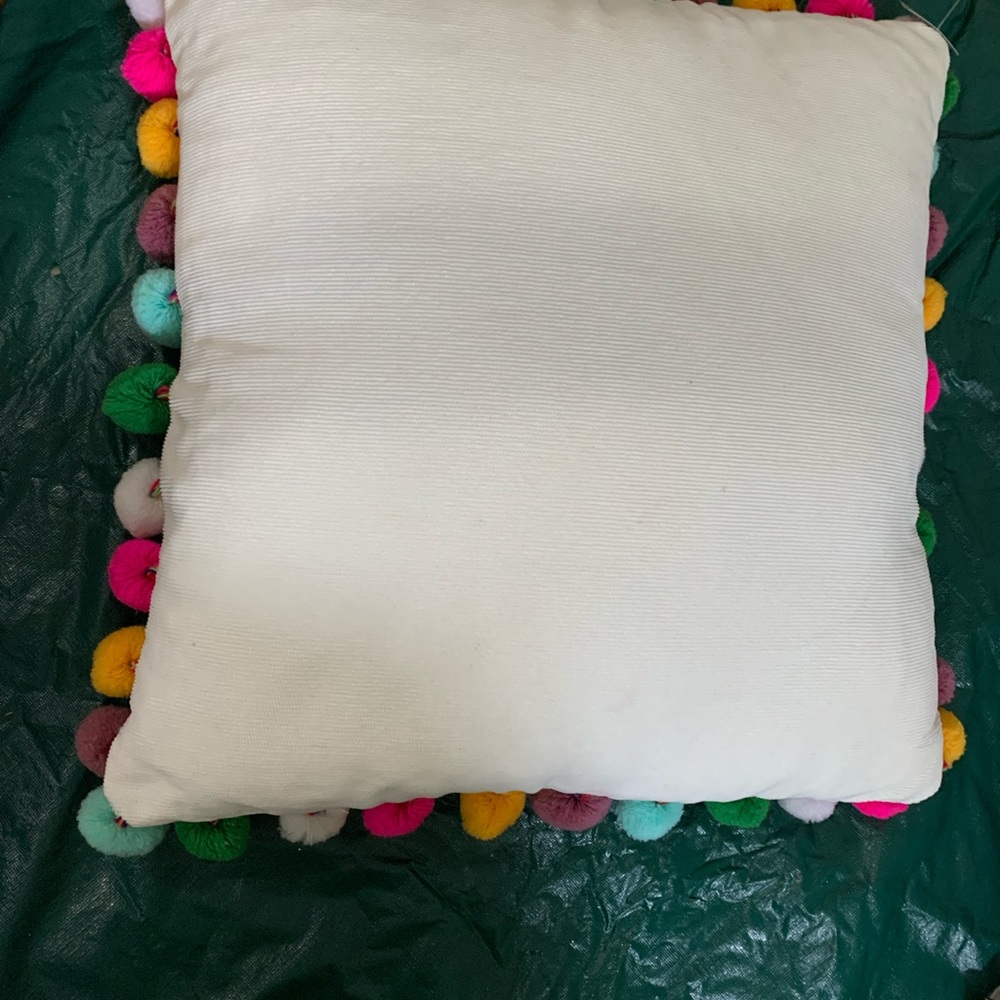 White Pillow with Colorful Pom Poms